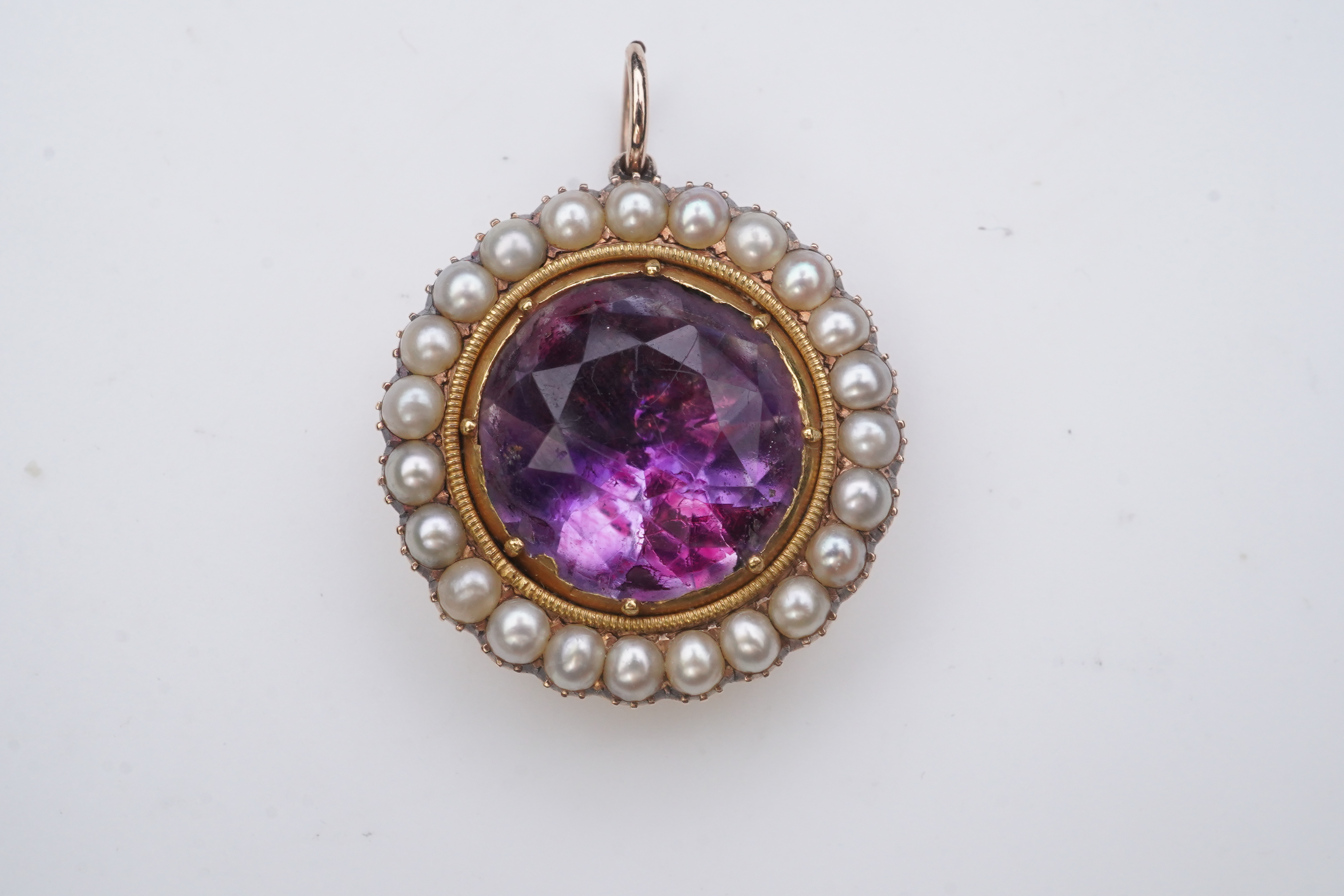 A Victorian amethyst and half pearl pendant, mid 19th century